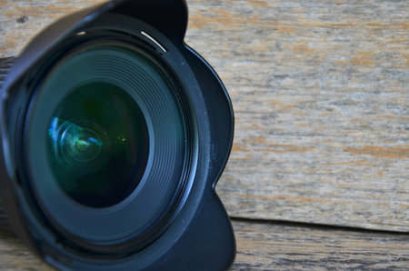 Black hood and shiny lens of cameraの写真素材