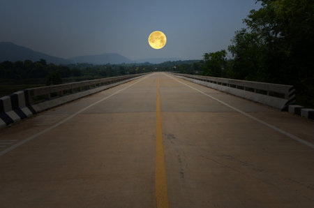 Long concrete bridge with beautiful full moonの写真素材