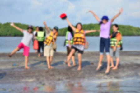 Blurry image of happy tourist on the black beachの写真素材