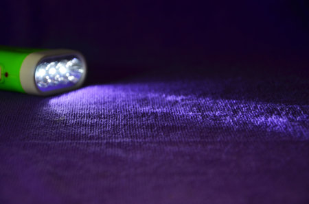 Violet clothes floor in the light of flashlightの写真素材