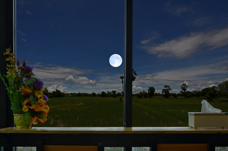 Beautiful full moon in early morning from windows of resortの写真素材