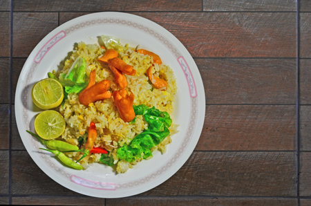 Dish of yummy fried rice with hotdog and lettuceの写真素材