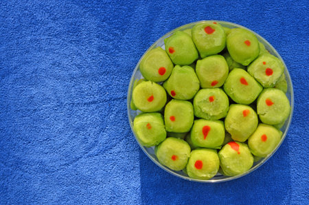 Green spring roll pastry with red spot box on blue clothesの写真素材