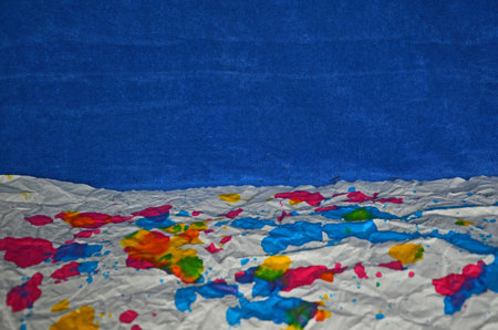Colored paper floor with blue cloth wallの写真素材