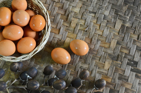 In and out basket of eggs on woven bamboo floorの写真素材