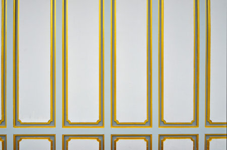 Golden square pattern on white wall