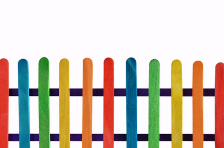 Beautiful colored lath fence with blue racks on white background
