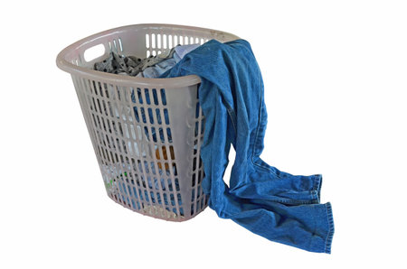 Old plastic basket of used clothes for washingの写真素材
