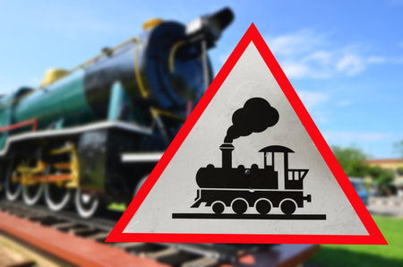 Train warning sign with blurry colored locomotive