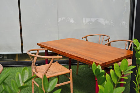Brown tables and chairs in rest area beside the building