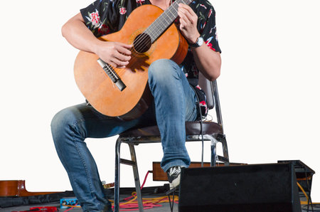 Man in blue jeans with classic guitar