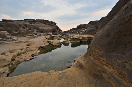 Clear water pond and cliff of the canyon in the morningの写真素材