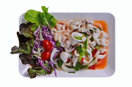 Hot spicy squid and vegetable salad dish on white backgroundの写真素材