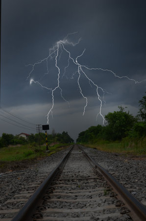 Scary lightning over the track in monsoon season in Thailandの写真素材
