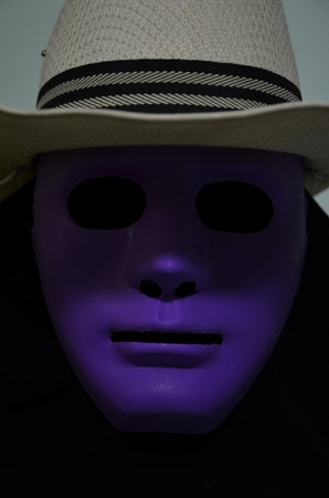 Scary hallow man in violet mask and black coatの写真素材