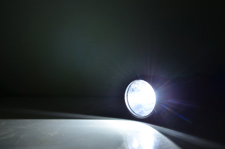Bright light and rays of torch on the floor with black background