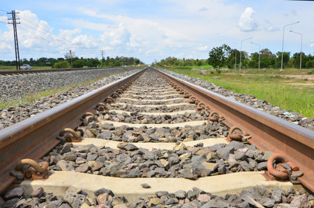 New long railway with canals under cloudy sky