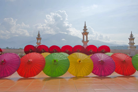 Beautiful colored umbrellas on tile floor in the light