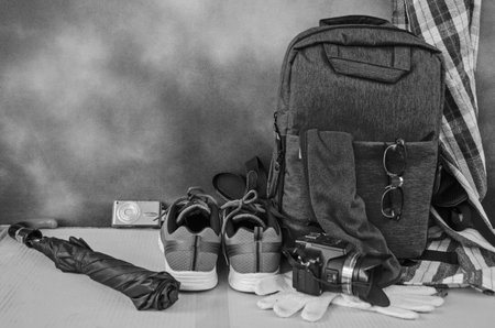 Black and white image of travel materials and tools