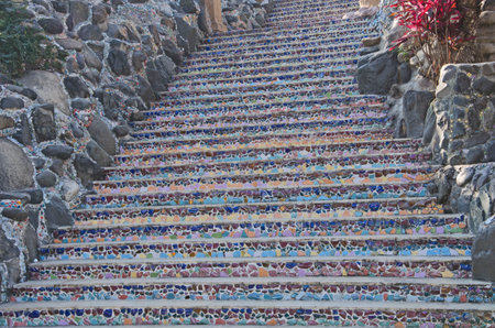 Beautiful colored scrap stairs with stone wallの写真素材