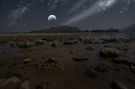 Bright stars in crescent night over the riverの写真素材