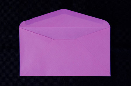 Pink paper envelope on black background