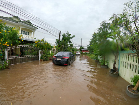 Nakornratchasima, Thailand, October 16, 2020 : Slowly running car in the flood above the roadのeditorial素材