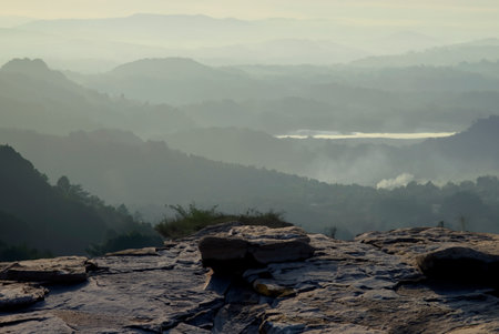 Rock courtyard cliff and beautiful valley bwith smoke and fog ackground in the morningの写真素材