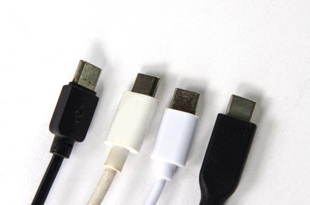USB type c portables for phone and computer linking on white paper background