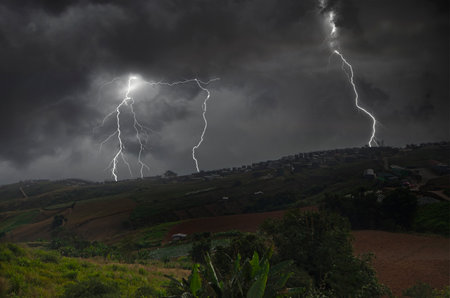 Dangerous lightning storm cover houses and agriculture farm on the mountains