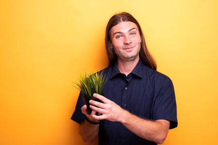 Man showing apartment plant in a potの写真素材
