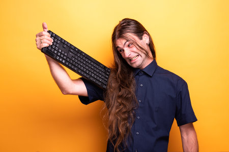 Inspiring male adult holding a keyboardの写真素材