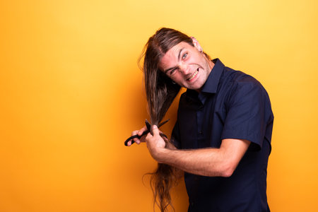 Funny face man cutting hairの写真素材