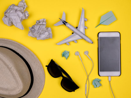 Hat, shades, smartphone, headphones, paper plane, toy plane, tossed jammed paper