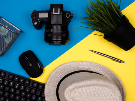Keyboard, hat, camera, mouse, plant in a potの写真素材
