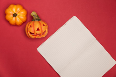 Halloween sculpted pumpkin funny and cute face along with full intact pumkin along notes paperの写真素材