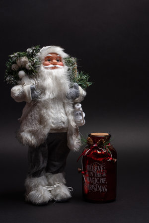 Close up of Santa Claus toy with a motivational jar for Christmas holidayの写真素材
