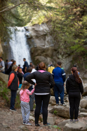 Pruncea Falls, Romania, 30th April 2019 - Group of tourists admire the beautiful waterfallのeditorial素材