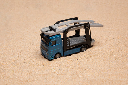 Isolated toy tow truck on very fine sand with copy spaceの写真素材