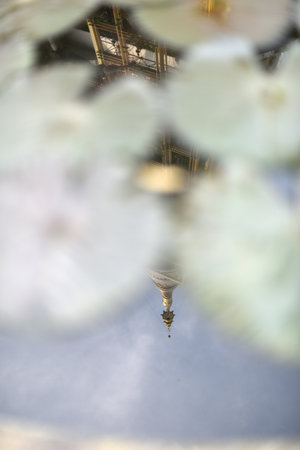A reflection of golden pagoda in the lotus pond representing the enlightenment at Sathira Dhammasathan, Bangkok, Thailand.の写真素材