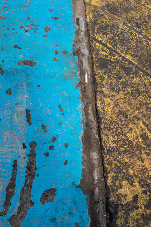 Fresh closeup turquoise color street texture, cropped only details showing rough painted and accidental patterns created by car wheels and weathers.の写真素材