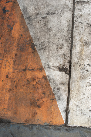 Fresh closeup orange, white and yellow color of street texture, cropped only details showing rough painted and accidental patterns created by car wheels and weathers.の写真素材