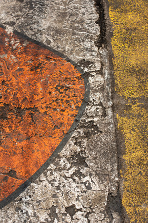 Fresh closeup orange, white and yellow color of street texture, cropped only details showing rough painted and accidental patterns created by car wheels and weathers.の写真素材