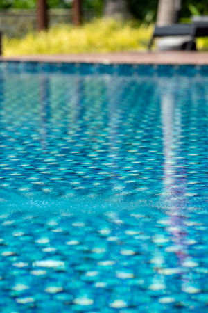 Swimming pool in a hotel With clear and clean blue good looking and reflecting water in the morning.