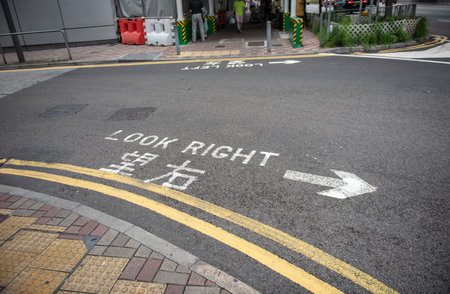 Yellow lines painted on the road, showing traffic rules guide for drivers and pedestrians to follow the laws.の写真素材