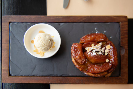 Apple tart tartin served with vanilla ice cream, sweetness and generous plate.