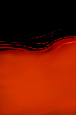 Deep red curve waves in a deep black dark background.の写真素材