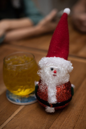 Small and cute Santa Claus doll placed on a wooden table, celebrating the big holiday, Christmas and New Year.の写真素材