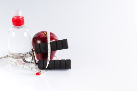 Fitness background with bottle of water ,dumbbell, handgrip and heartの写真素材