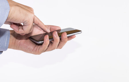 Man's hand holding a smartphone on white backgroundの写真素材
